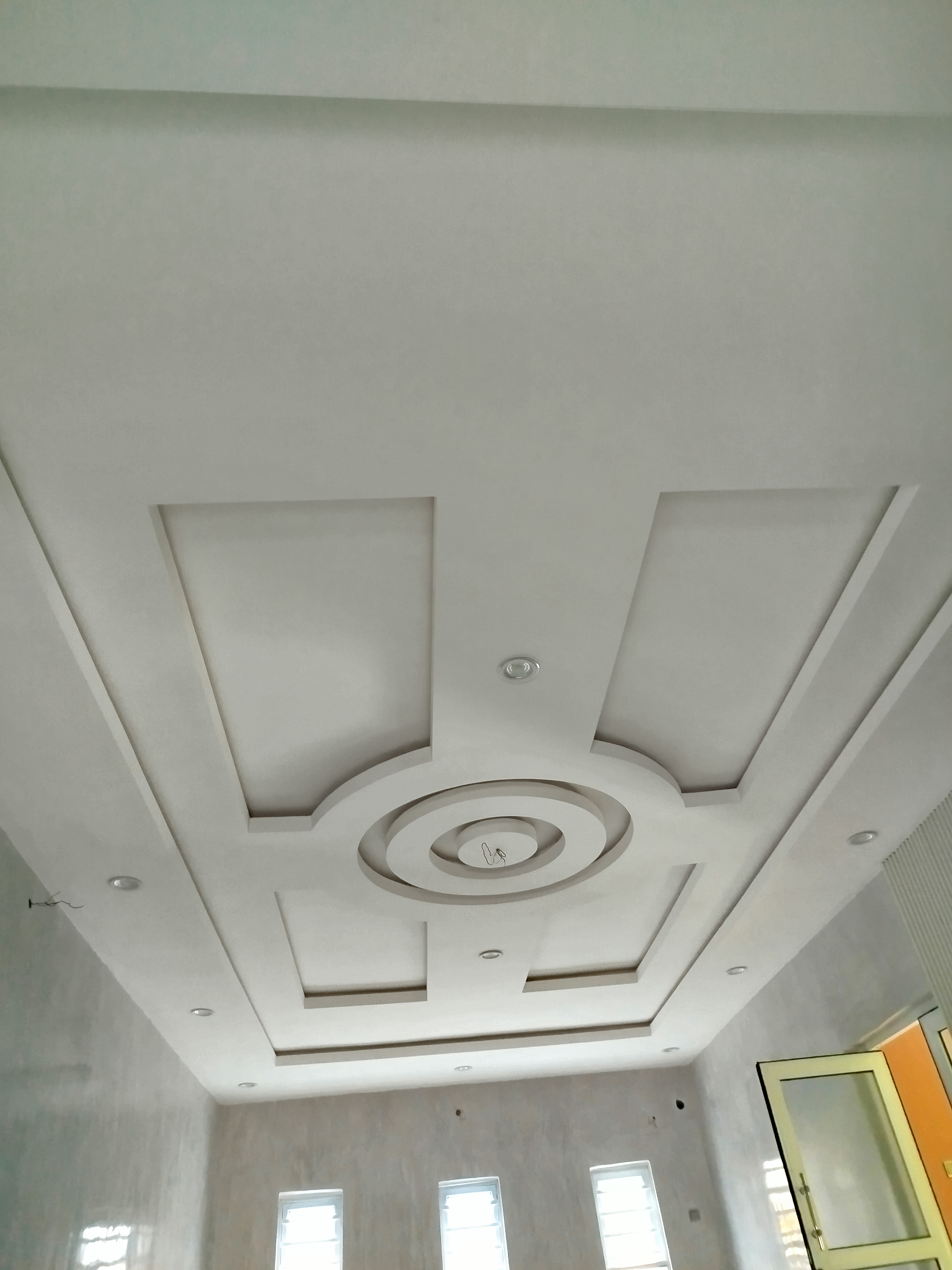 Layered POP ceiling with circle detail by Ajis Interior Creations